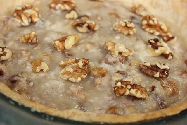 Bake at 350°F for 50-60 minutes. The pie is done when the edges are set but the center still jiggles slightly like Jell-O. It will continue to firm up during cooling. Overbaking creates dry, hard filling instead of the desired gooey texture.